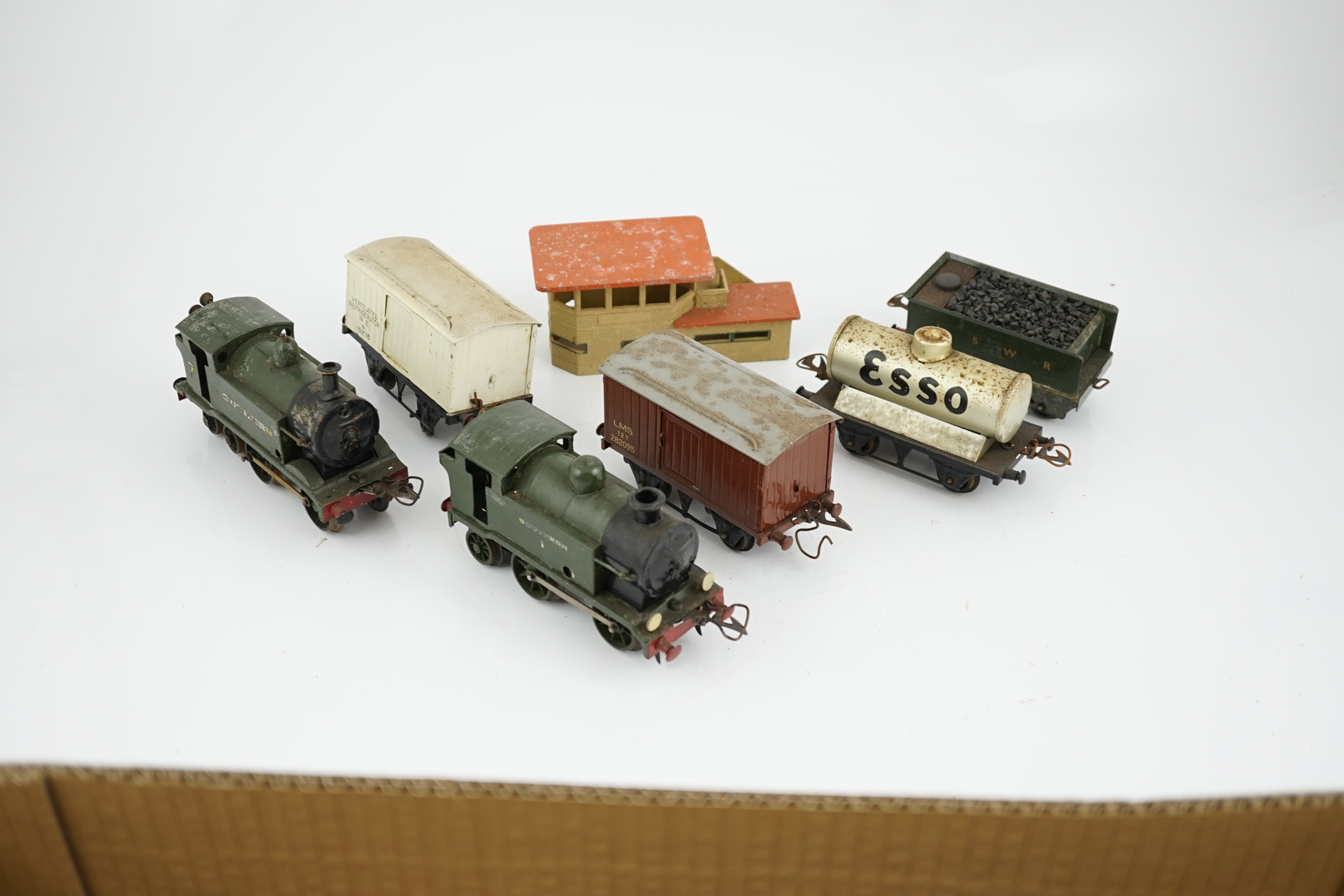 Fourteen 0 gauge tinplate etc. railway items, including three clockwork locomotives; an LSWR 4-4-0 tender loco, an SR 0-4-4T loco and an SR 0-4-2T loco, together with nine Hornby freight wagons, a Bing milk traffic van a